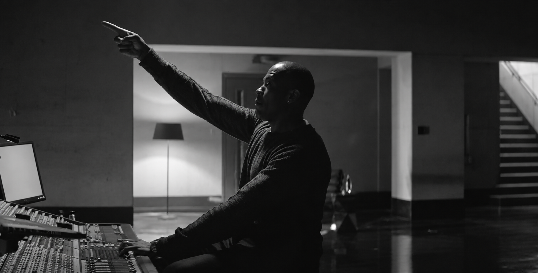 Black and white frame of Dr. Dre at a mixing desk, from Beats 10 Year Mixtape